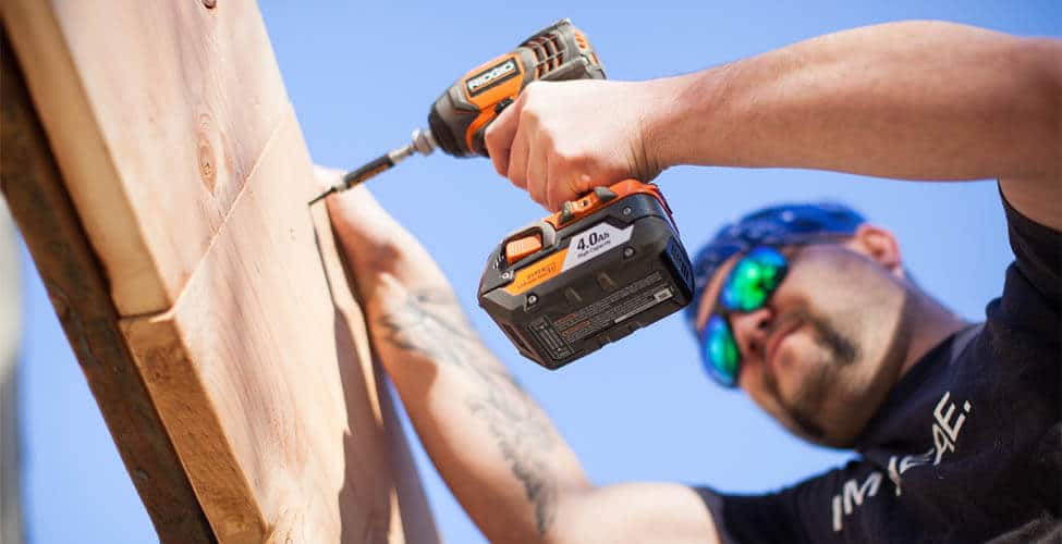 worker drilling screws